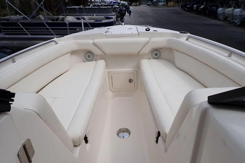 Slide: The Image of 2016 Grady-White Freedom 275 boat interior with white seating and speakers. - 6