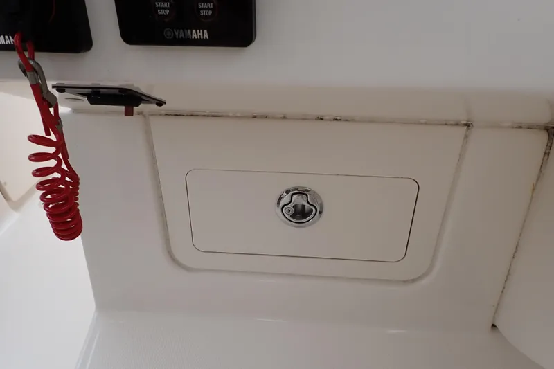Slide: The Image of Control panel of 2016 Grady-White Freedom 275 boat with Yamaha start-stop buttons. - 73