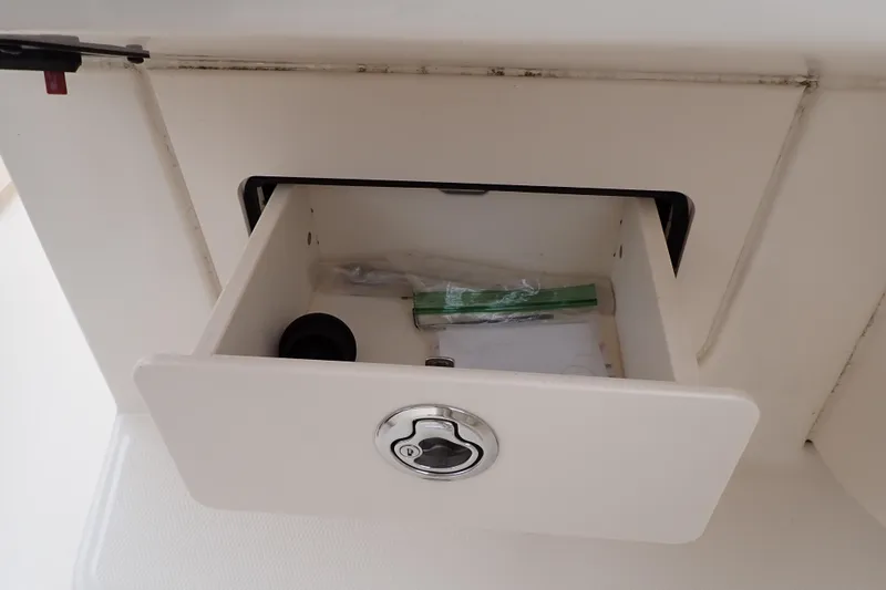 Slide: The Image of Open storage compartment on 2016 Grady-White Freedom 275 boat. - 74