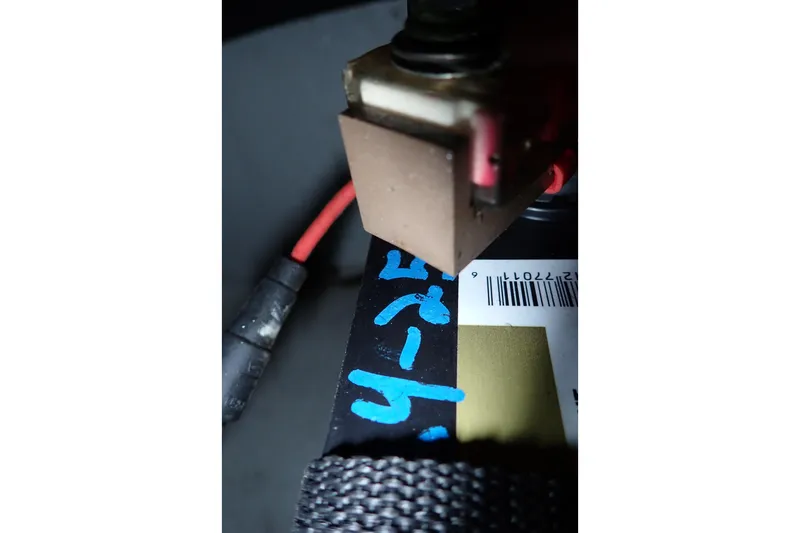 Slide: The Image of Close-up of a Grady-White Freedom 275 boat component, featuring wiring and a barcode. - 82