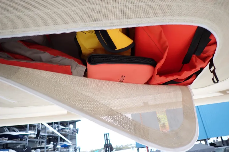 Slide: The Image of Storage compartment on 2016 Grady-White Freedom 275 boat with safety gear and equipment. - 89