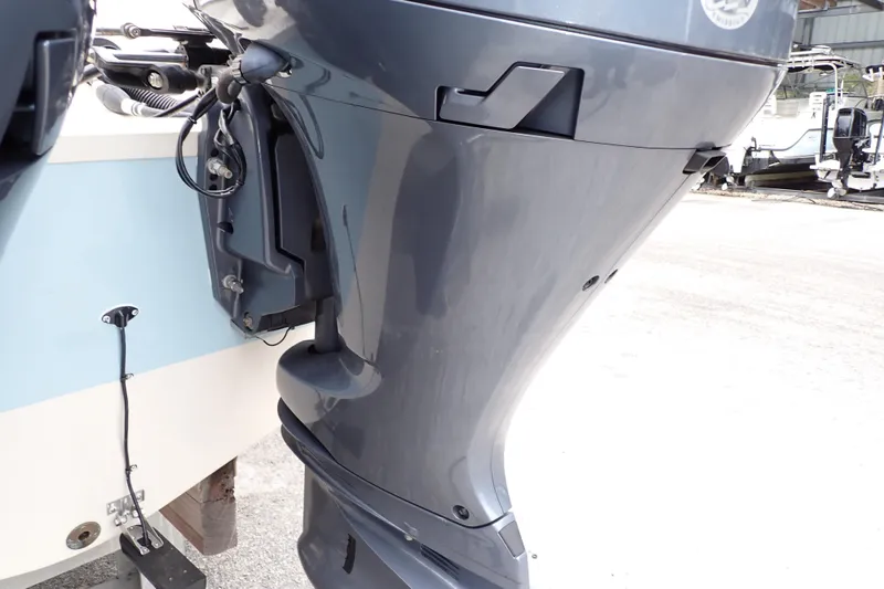 Slide: The Image of 2016 Grady-White Freedom 275 boat engine close-up in a marina setting. - 99