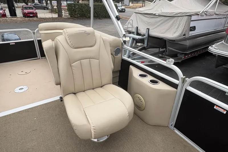 Slide: The Image of 2015 Bennington 20 SLMX boat interior with beige captain's chair and cup holders. - 12