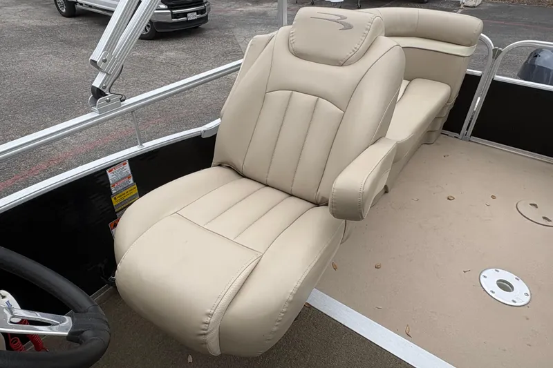 Slide: The Image of 2015 Bennington 20 SLMX boat with beige captain's chair and steering wheel. - 13