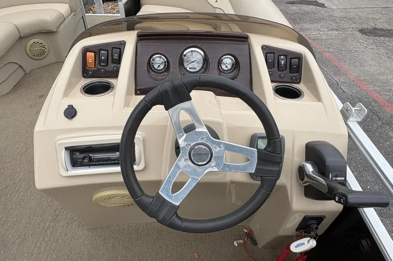 Slide: The Image of 2015 Bennington 20 SLMX boat dashboard with steering wheel and control panel. - 14