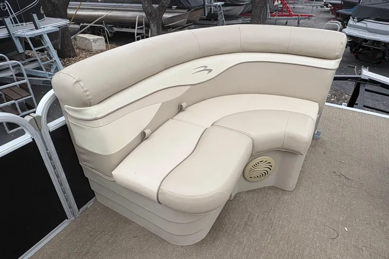 Slide: The Image of 2015 Bennington 20 SLMX boat seating with beige upholstery and integrated speaker. - 15
