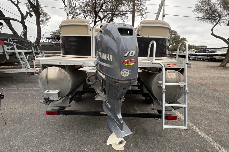 Slide: The Image of 2015 Bennington 20 SLMX pontoon boat with Yamaha 70 outboard motor, parked on trailer. - 6