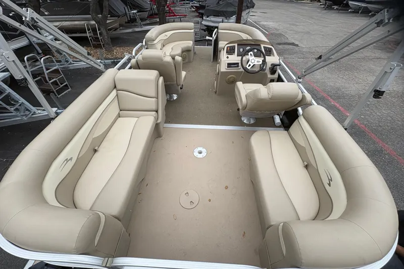 Slide: The Image of 2015 Bennington 20 SLMX pontoon boat with beige seating and steering console. - 9