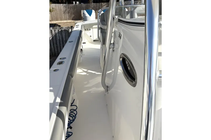 Slide: The Image of 2018 Regulator 34 Center Console boat deck with stainless steel railings and seating. - 11