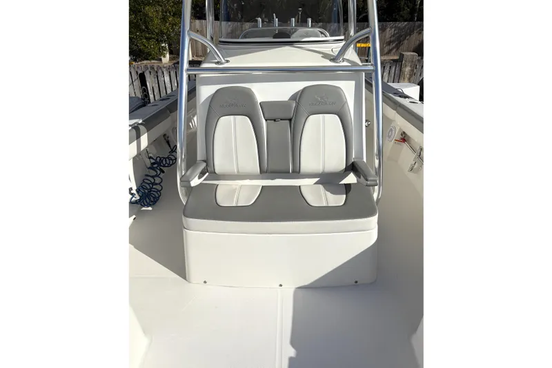 Slide: The Image of 2018 Regulator 34 Center Console boat seating with gray and white cushioned seats. - 15