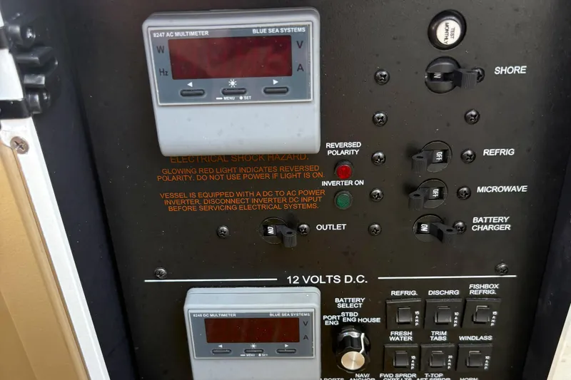 Slide: The Image of Control panel of a 2018 Regulator 34 Center Console boat with multimeter and switches. - 16