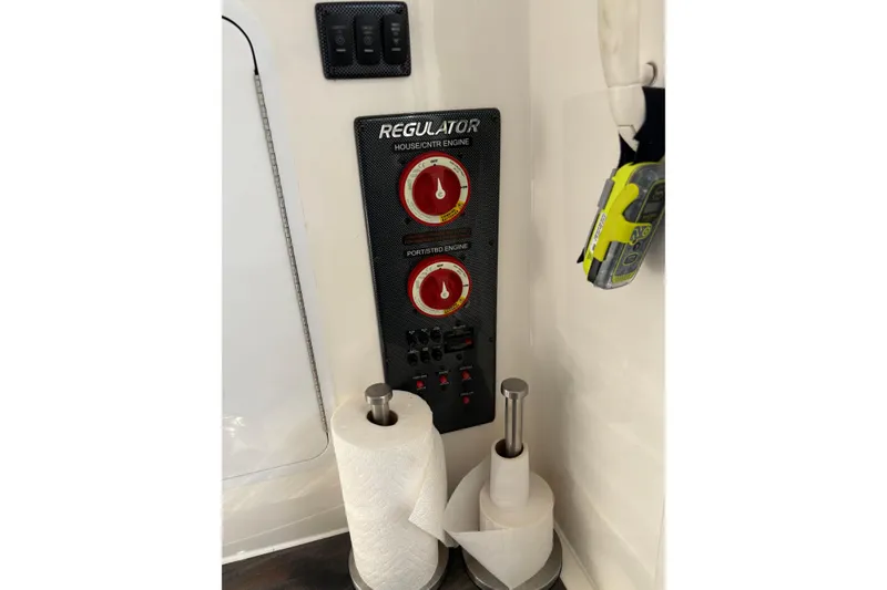 Slide: The Image of 2018 Regulator 34 Center Console control panel with switches and paper towel holders. - 17