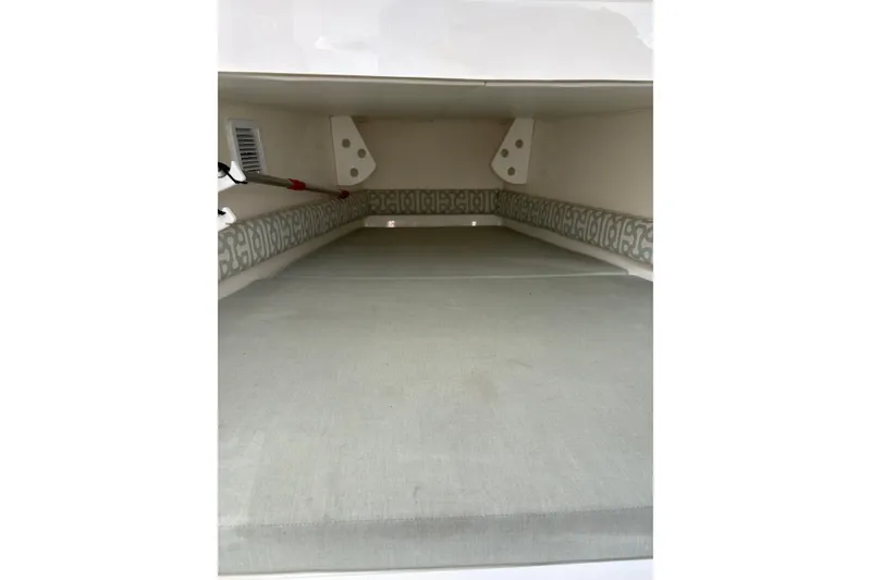 Slide: The Image of 2018 Regulator 34 Center Console interior storage compartment with cushioned seating. - 19