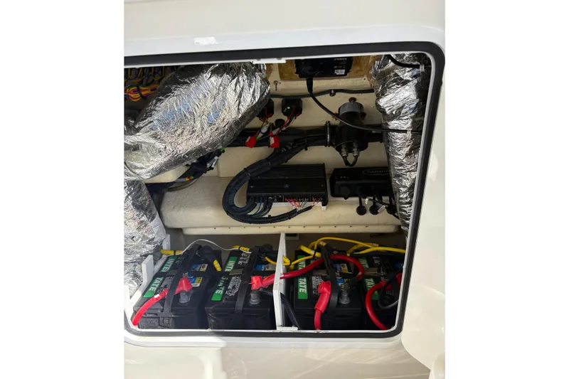 Slide: The Image of Electrical compartment of a 2018 Regulator 34 Center Console boat with batteries and wiring. - 20
