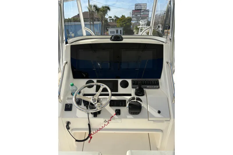 Slide: The Image of 2018 Regulator 34 Center Console helm with steering wheel and controls. - 26