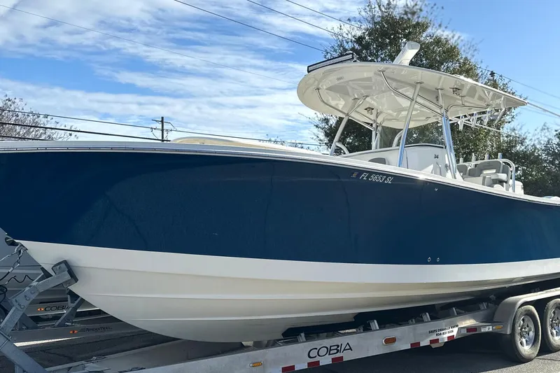 Slide: The Image of 2018 Regulator 34 Center Console boat on trailer under blue sky. - 3