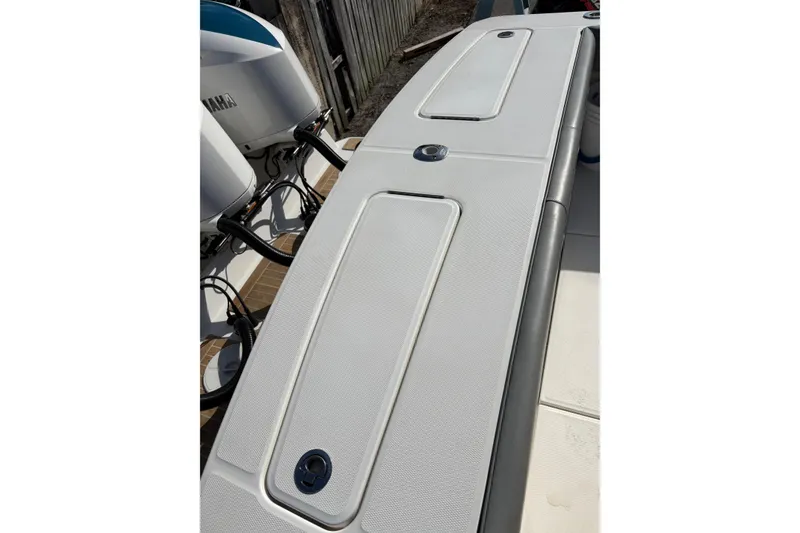Slide: The Image of 2018 Regulator 34 Center Console boat deck with Yamaha engines in background. - 30
