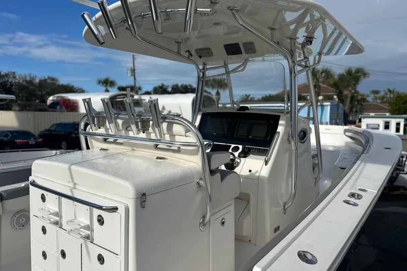 Slide: The Image of 2018 Regulator 34 Center Console boat with sleek design and advanced navigation equipment. - 5