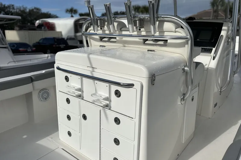 Slide: The Image of 2018 Regulator 34 Center Console boat interior with storage compartments and rod holders. - 7