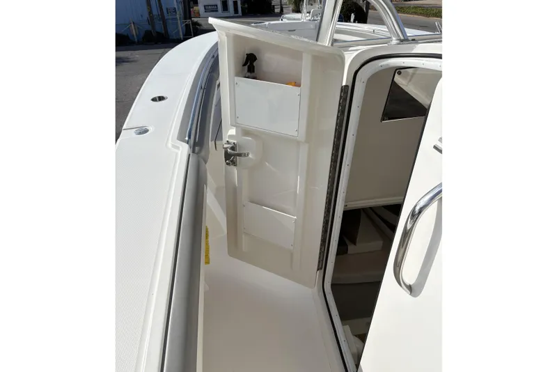Slide: The Image of 2018 Regulator 34 Center Console boat with open cabin door, showcasing interior access. - 8