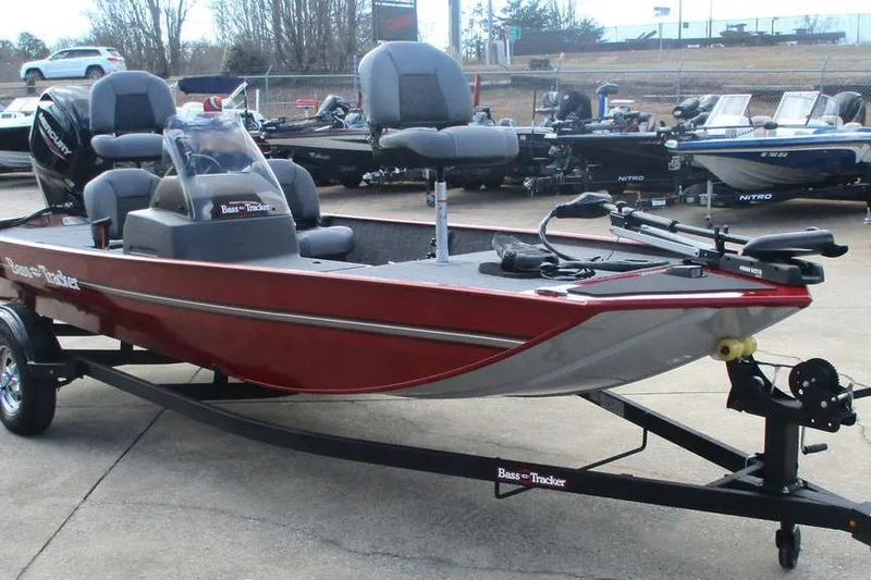 Slide: The Image of 2026 Tracker Bass Tracker Classic XL boat on trailer, red exterior, parked outdoors. - 10