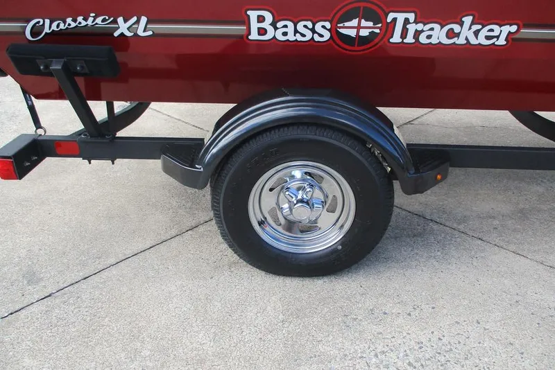 Slide: The Image of 2026 Tracker Bass Tracker Classic XL trailer with chrome wheel on concrete surface. - 11