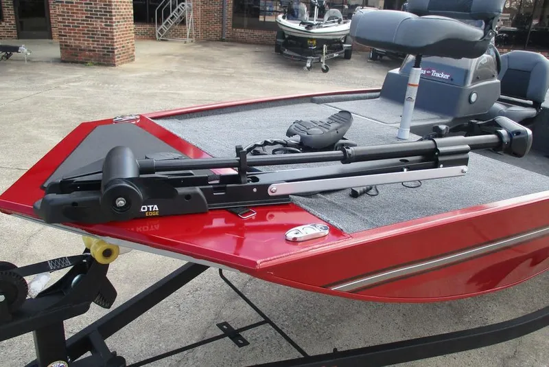 Slide: The Image of 2026 Tracker Bass Tracker Classic XL boat with trolling motor on red deck. - 12