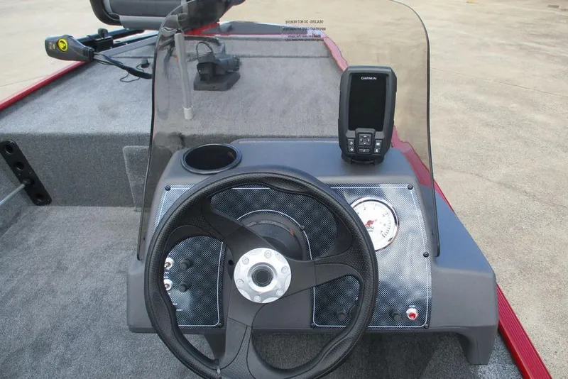 Slide: The Image of 2026 Tracker Bass Tracker Classic XL dashboard with steering wheel and Garmin device. - 6