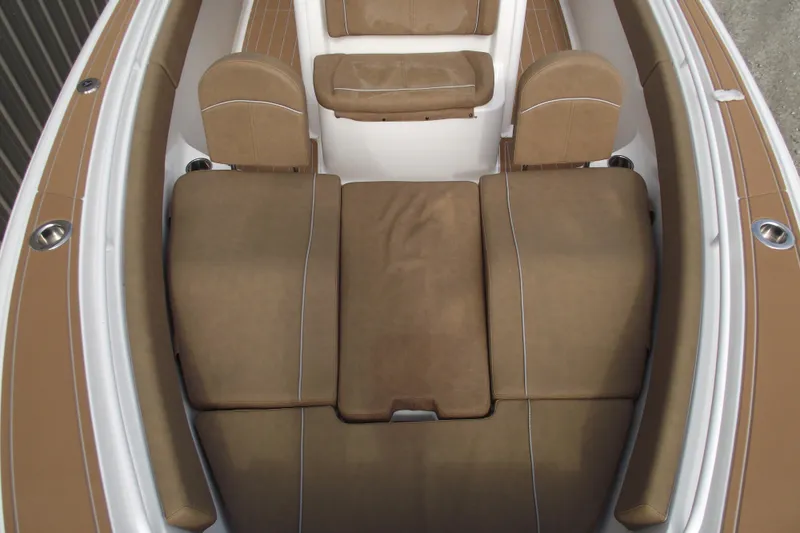 Slide: The Image of 2023 Sea Hunt Ultra 265 SE boat interior with brown cushioned seating. - 11