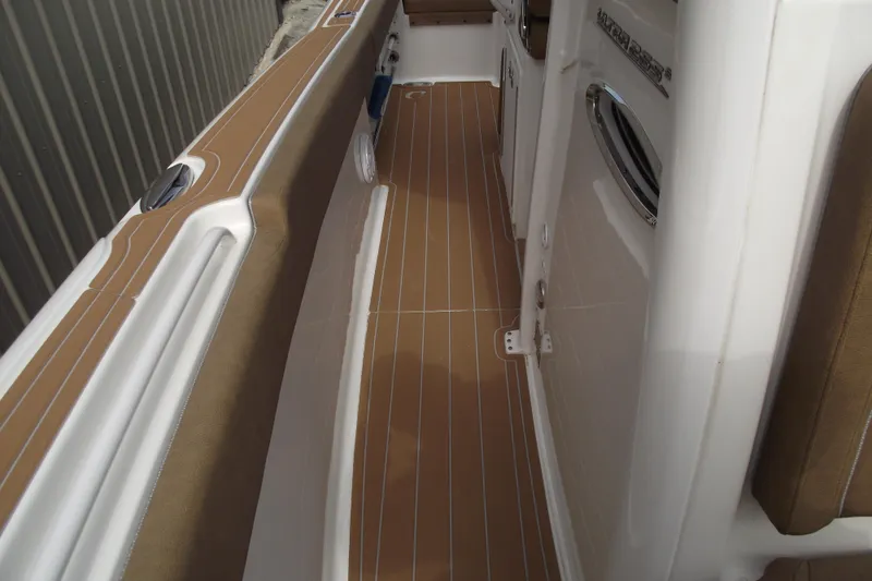Slide: The Image of 2023 Sea Hunt Ultra 265 SE boat interior with brown and white deck. - 15
