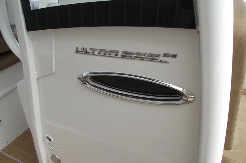 Slide: The Image of 2023 Sea Hunt Ultra 265 SE boat interior detail with model emblem. - 16