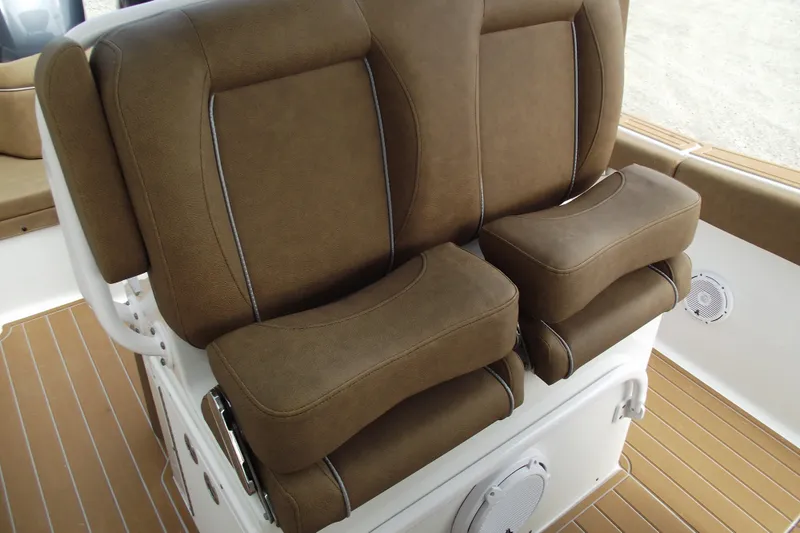 Slide: The Image of 2023 Sea Hunt Ultra 265 SE boat seats with brown upholstery and white accents. - 17