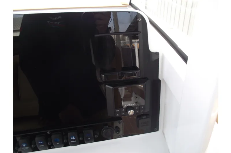 Slide: The Image of 2023 Sea Hunt Ultra 265 SE dashboard with JL Audio system and control panel. - 20