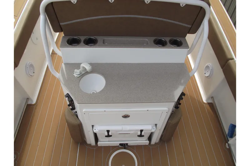 Slide: The Image of 2023 Sea Hunt Ultra 265 SE boat interior with sink and cup holders. - 23