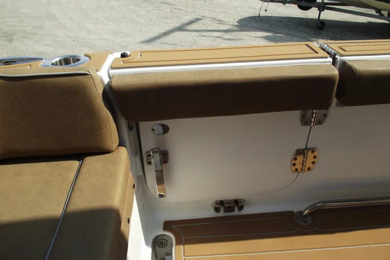 Slide: The Image of 2023 Sea Hunt Ultra 265 SE boat interior with brown cushioned seating and stainless steel fixtures. - 26