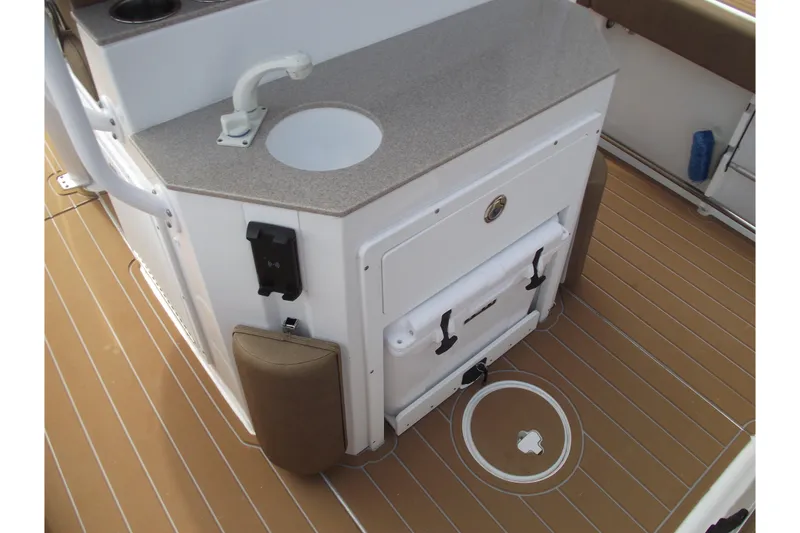 Slide: The Image of 2023 Sea Hunt Ultra 265 SE boat interior with sink and storage. - 29