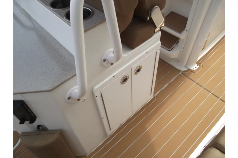 Slide: The Image of 2023 Sea Hunt Ultra 265 SE interior with sleek cabinetry and cushioned seating. - 31