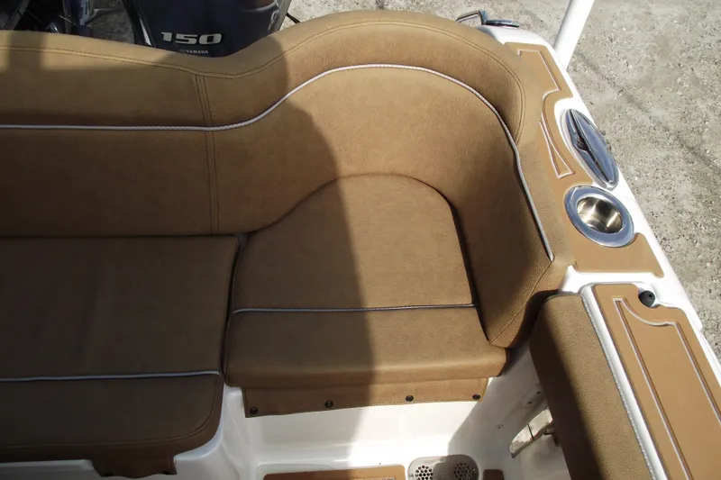 Slide: The Image of 2023 Sea Hunt Ultra 265 SE boat interior with tan seating and cup holder. - 35