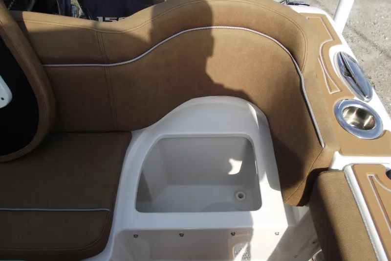 Slide: The Image of 2023 Sea Hunt Ultra 265 SE boat interior with brown seating and storage compartment. - 38