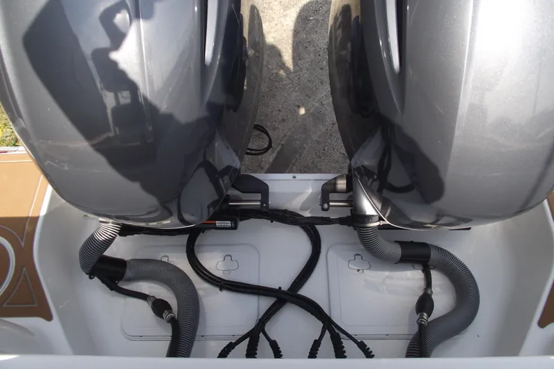 Slide: The Image of 2023 Sea Hunt Ultra 265 SE boat engine compartment with dual motors and wiring. - 8