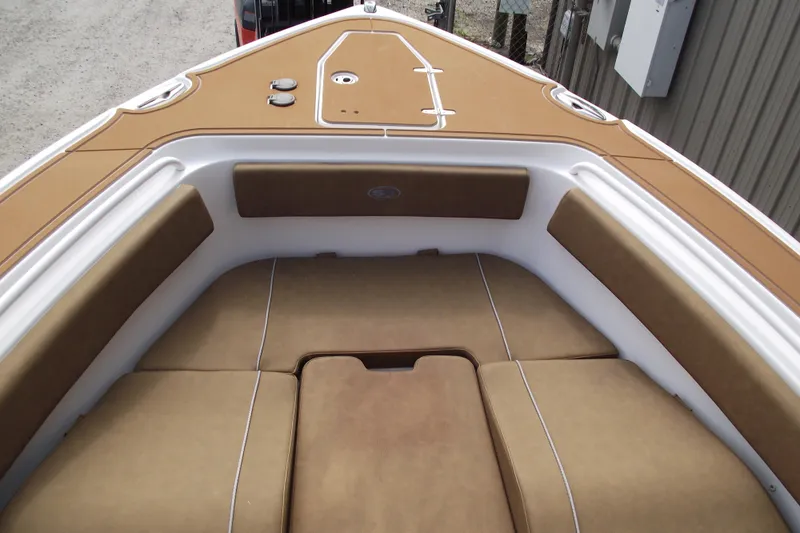 Slide: The Image of 2023 Sea Hunt Ultra 265 SE boat interior with tan cushioned seating. - 9