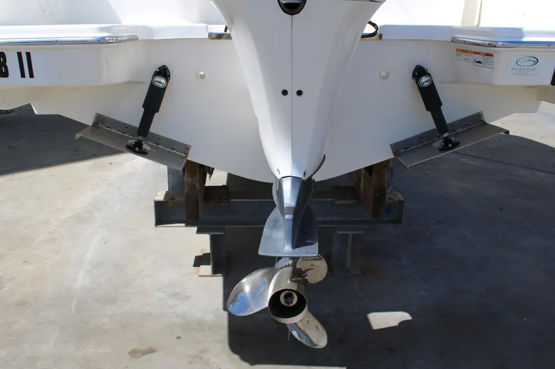 Slide: The Image of 2020 Pursuit DC 235 Dual Console boat stern with propeller and trim tabs. - 12