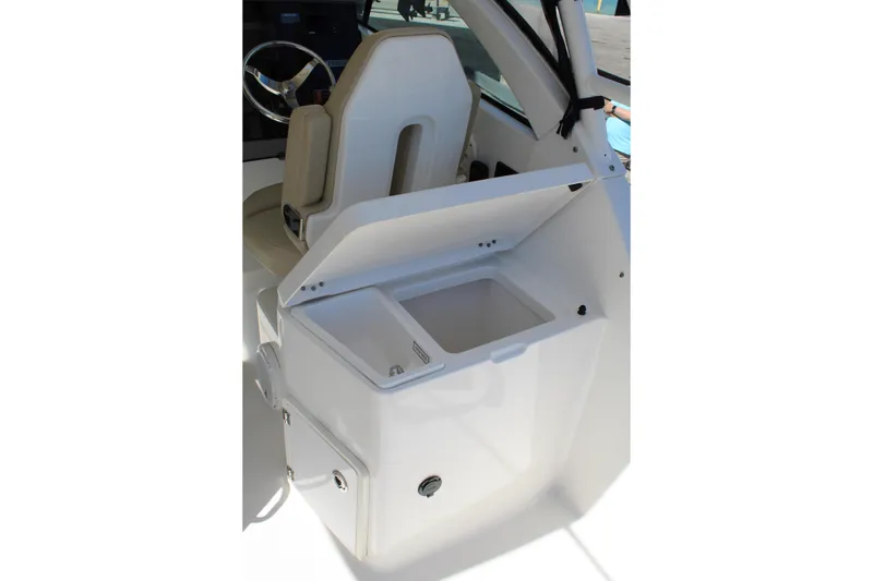 Slide: The Image of 2020 Pursuit DC 235 Dual Console boat interior with open storage compartment. - 13
