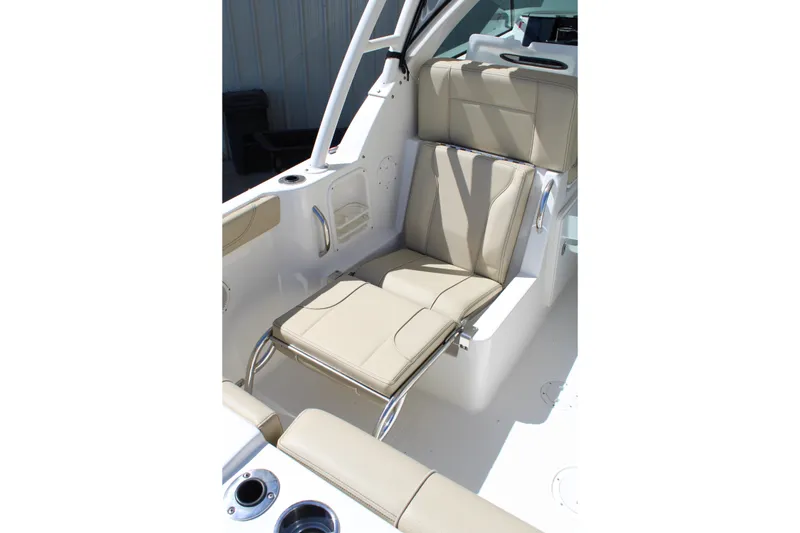 Slide: The Image of 2020 Pursuit DC 235 Dual Console boat seat with beige upholstery and stainless steel accents. - 14