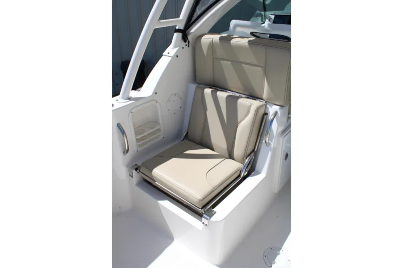 Slide: The Image of 2020 Pursuit DC 235 Dual Console boat seat with beige upholstery and sleek design. - 18
