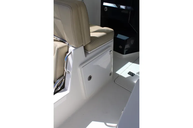 Slide: The Image of 2020 Pursuit DC 235 Dual Console interior with beige seating and storage compartment. - 21