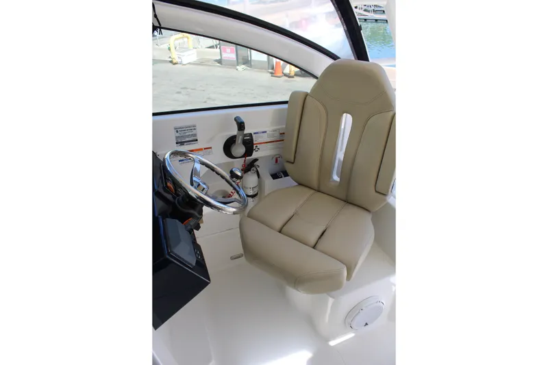 Slide: The Image of 2020 Pursuit DC 235 Dual Console storage compartment with open door and visible shelves. - 23