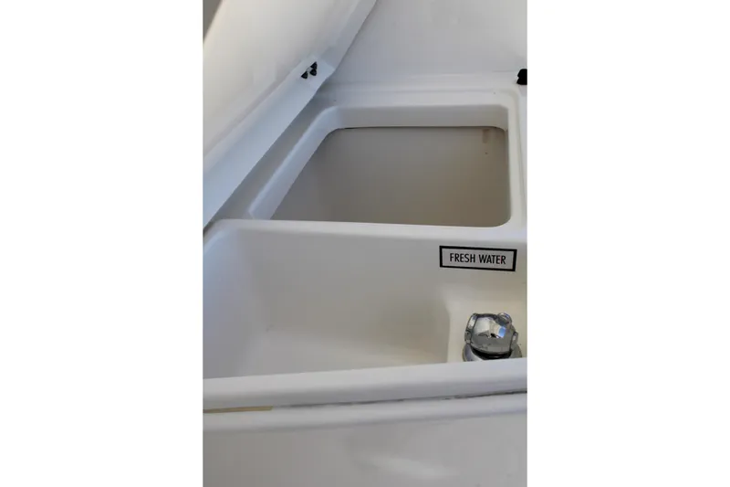 Slide: The Image of 2020 Pursuit DC 235 Dual Console helm with beige captain's seat and steering wheel. - 24