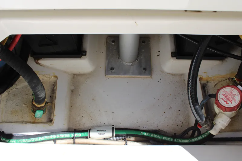 Slide: The Image of 2020 Pursuit DC 235 Dual Console boat plumbing system with hoses and valves. - 35