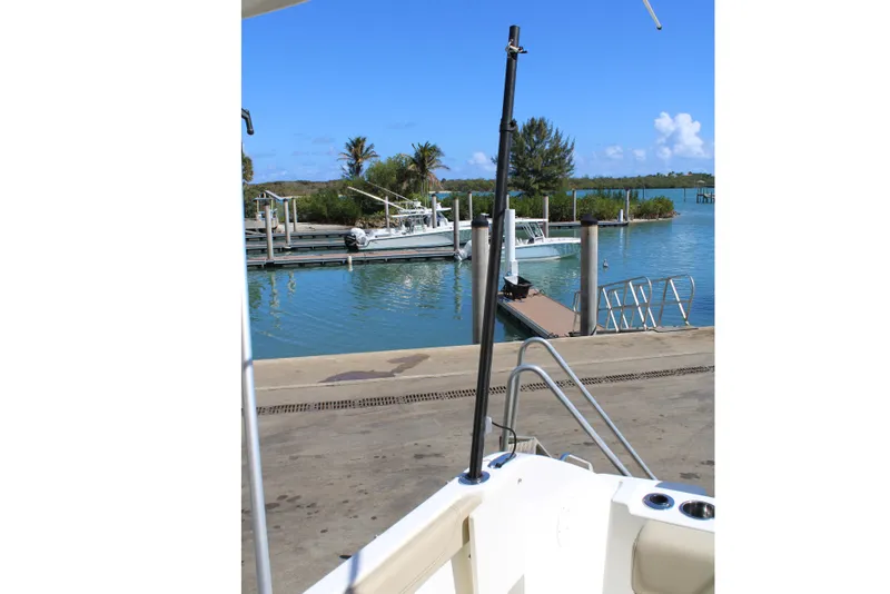 Slide: The Image of 2020 Pursuit DC 235 Dual Console boat at dockside with people nearby. - 41